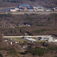 MCI-Cedar Junction at Walpole, with Gillette Stadium in the background, seen from the air in 2015. The prison, which opened in 1955, needs about $30 million in infrastructure repairs, according to the state's Department of Correction. (Christopher Evans/MediaNews Group/Boston Herald via Getty Images)