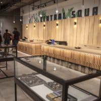 Yamba Market staff talk by the sales counter at as the store stands ready for opening day on Monday. (Robin Lubbock/WBUR)