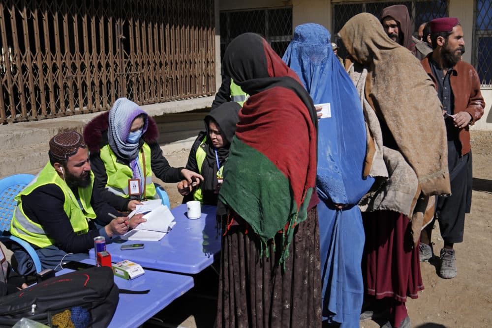Afghans register to receive food supplies during a distribution of humanitarian aid for families in need, in Kabul, Afghanistan, Wednesday, Feb. 16, 2022. (Hussein Malla/AP)
