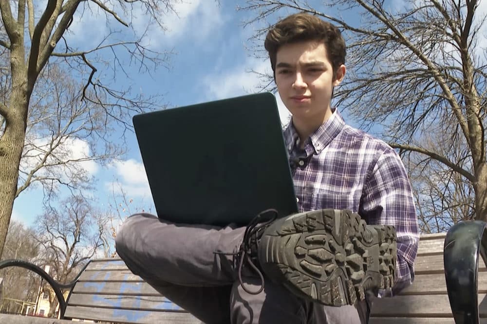 Harvard freshman Marco Burstein, 18, of Los Angeles, works on his computer near Harvard University in Cambridge. (Rodrique Ngowi/AP)