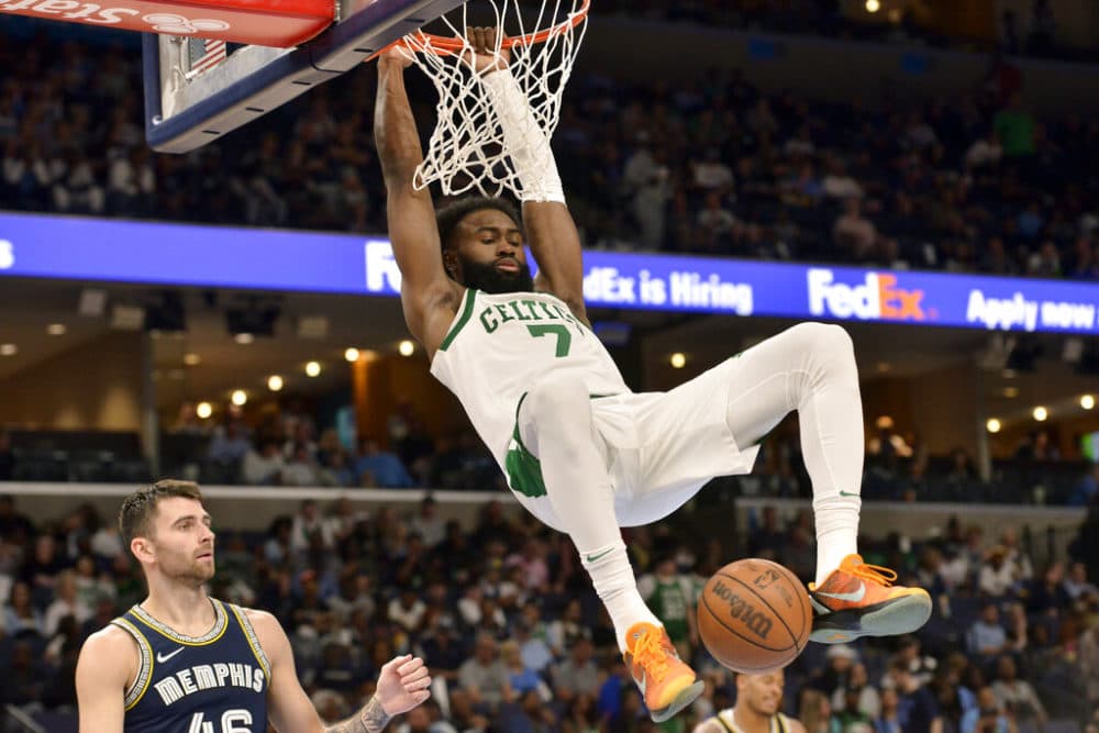 Celtics guard Jaylen Brown dunks past Memphis Grizzlies guard John Konchar in the second half of an NBA basketball game Sunday April 10, 2022 in Memphis, Tennessee.  (Brandon Dill/AP)