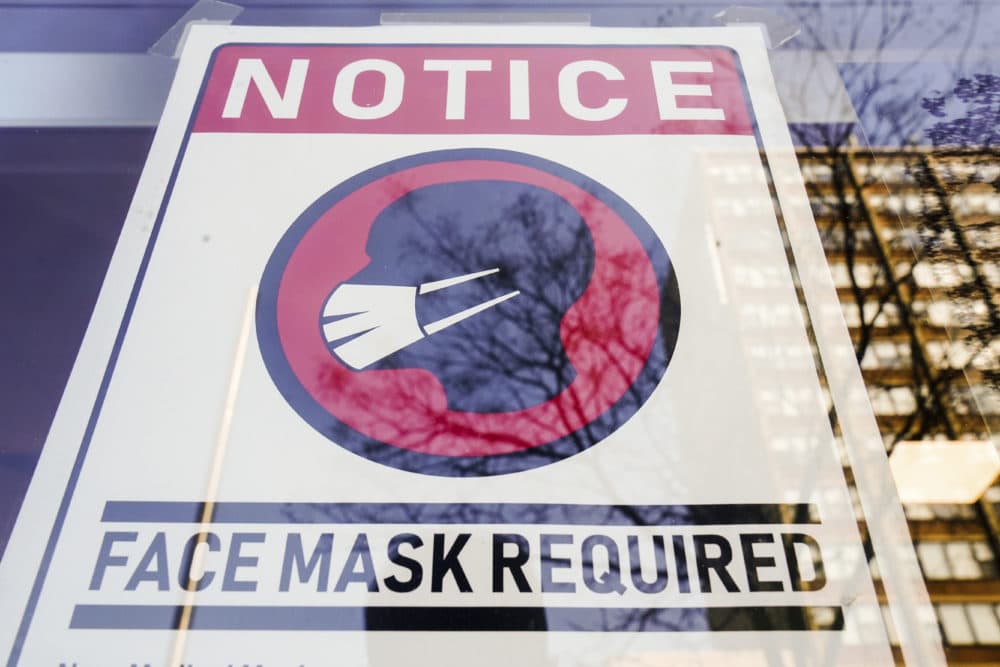 A sign requiring masks as a precaution against the spread of the coronavirus on a store front in Philadelphia, is seen Feb. 16, 2022. (Matt Rourke/AP)