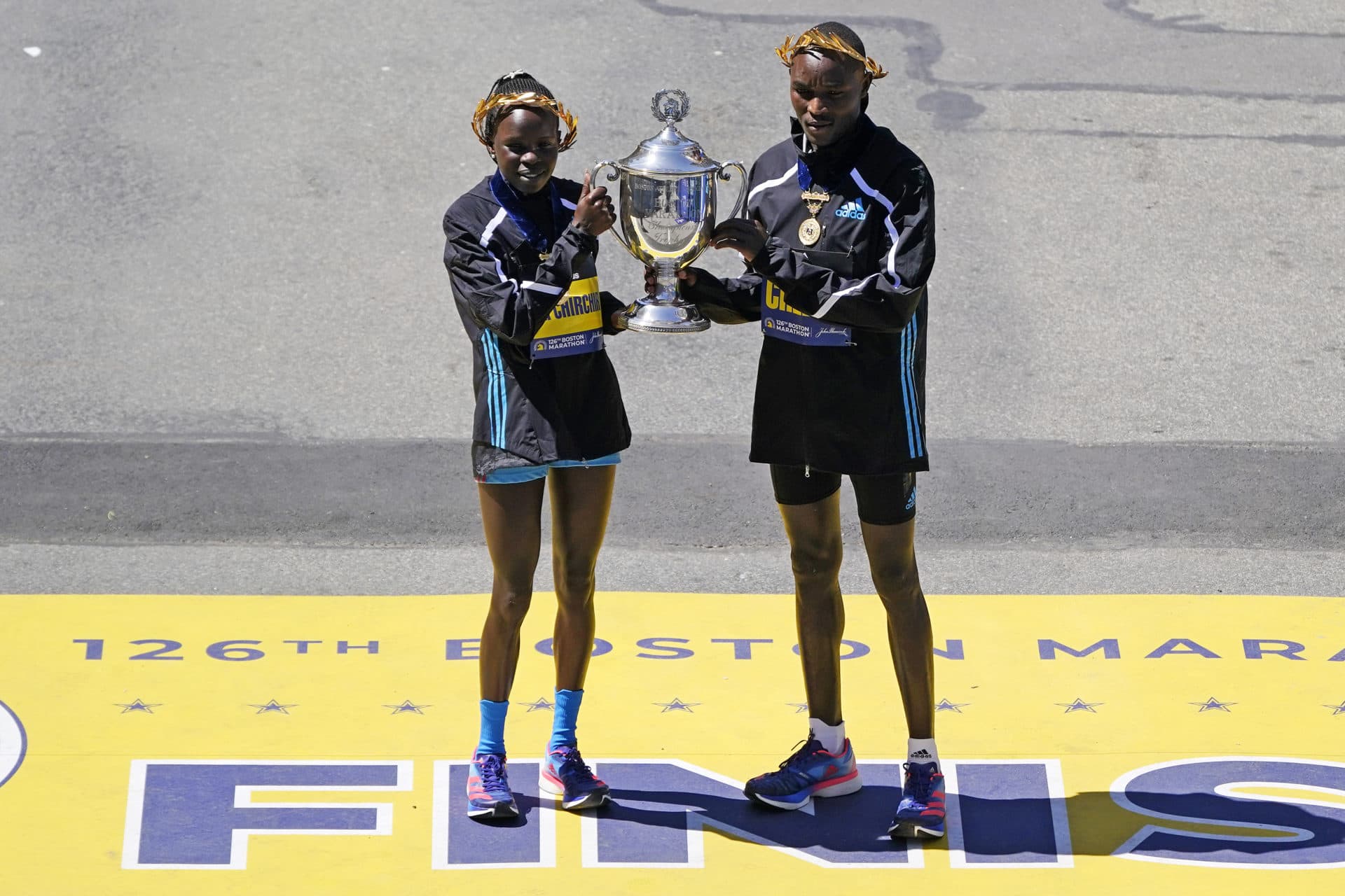 2022 Boston Marathon women's winner Peres Jepchirchir of Kenya (left) and men's winner Evans Chebet of Kenya pose at the finish line.  (Charles Krupa/AP)