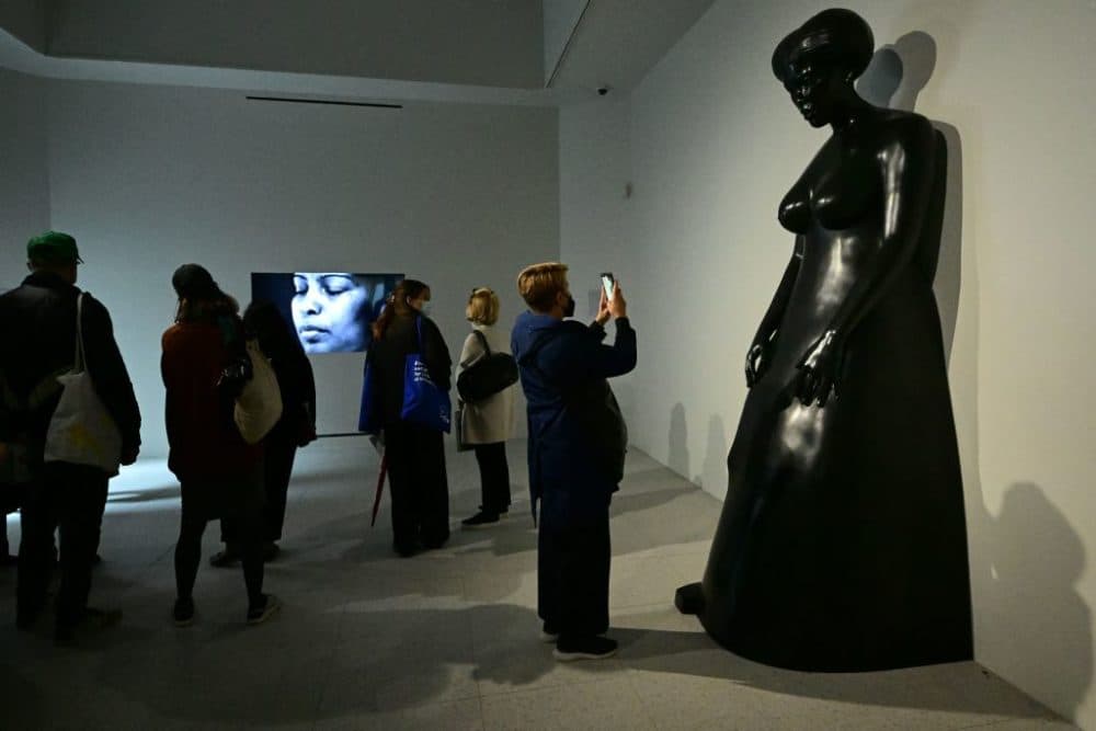 Visitors take in Simone Leigh's works in the U.S. Pavilion. The exhibition runs through November. (AFP/Vincenzo Pinto via Getty Images)
