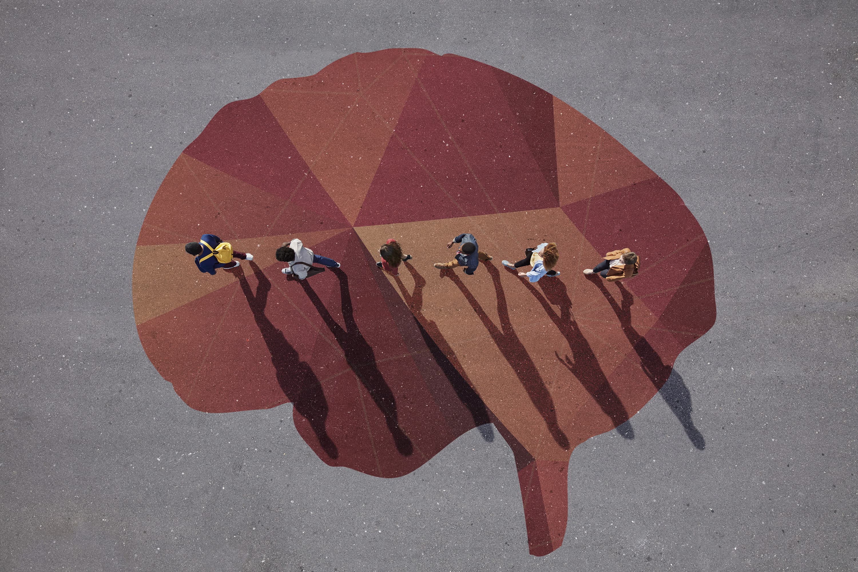 Group of young adults, photographed from above, on various painted tarmac surface, at sunrise. (Klaus Vedfelt/Getty Images)