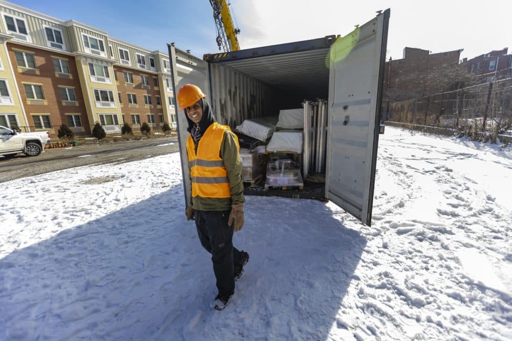 Kannan Thiruvengadam walks away from the shipping container after inspecting its contents. (Jesse Costa/WBUR)