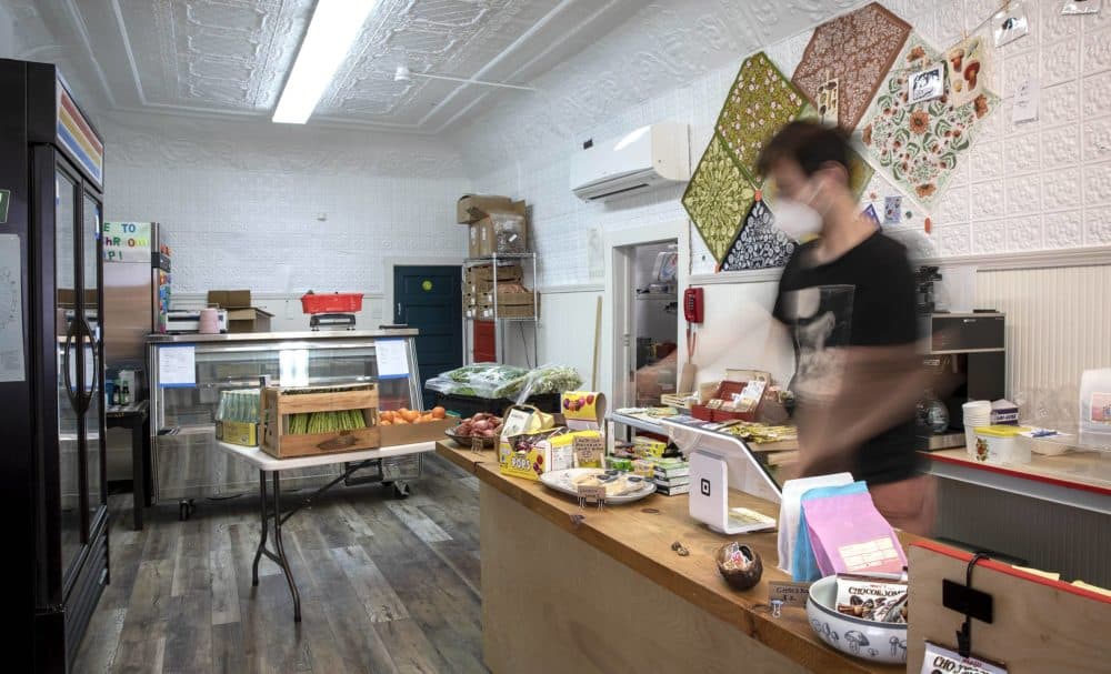 Tyler Akabane makes some final preparations for the opening of the Mushroom Shop in Somerville. (Robin Lubbock/WBUR)