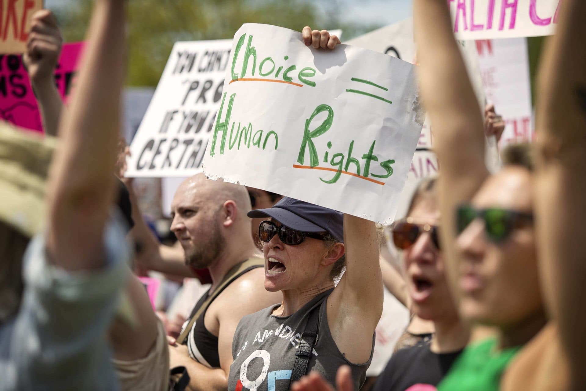 A protester holds up a sign saying "Choice = Human Rights" at the Bans Off Our Bodies rally on Boston Common. (Robin Lubbock/WBUR)