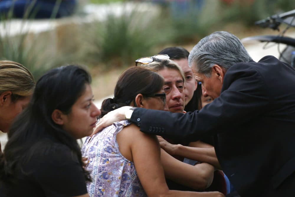 The Archbishop of San Antonio, Gustavo Garcia Seller, comforts families outside of the Civic Center following a deadly school shooting at Robb Elementary School in Uvalde, Texas Tuesday, May 24, 2022. (AP Photo/Dario Lopez-Mills)