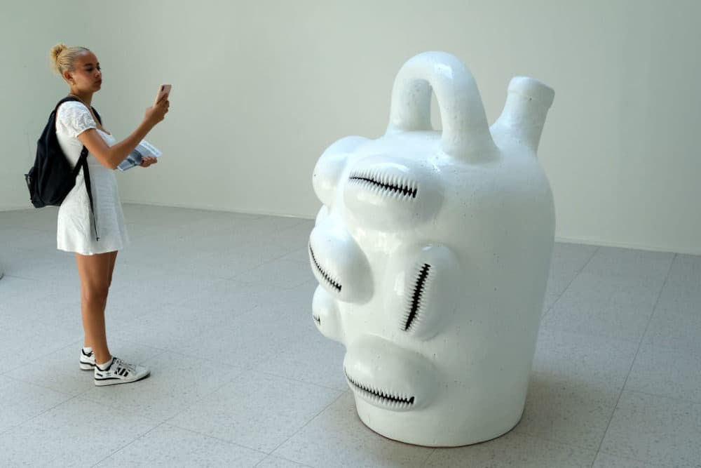 A visitor to the Venice Biennale photographs Simone Leigh's sculpture entitled "Jug." Leigh has been awarded a Golden Lion at the 59th International Art Exhibition. (Giuseppe Cottini/Getty Images)