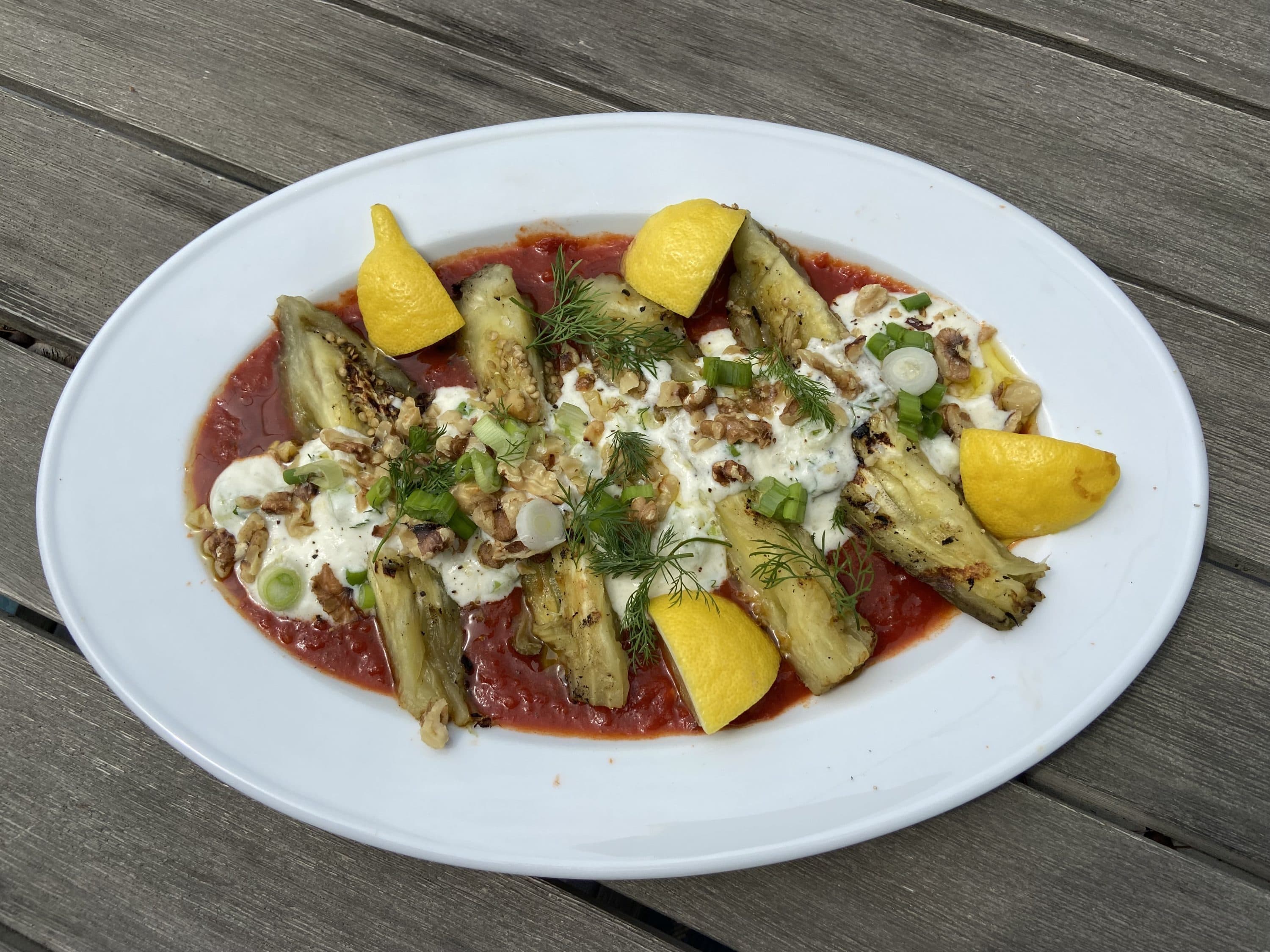 Middle Eastern-inspired grilled eggplant with tomato sauce and spiced yogurt. (Kathy Gunst/Here & Now)