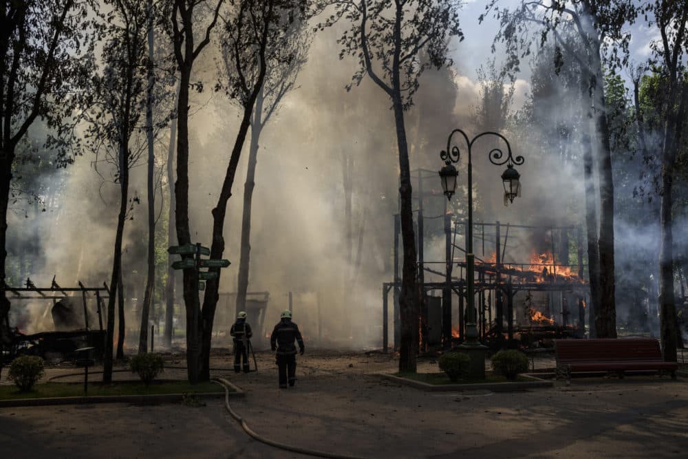 Firefighters extinguish a fire following a Russian bombardment at a park in Kharkiv, Ukraine, Tuesday, May 3, 2022. (Felipe Dana/AP)