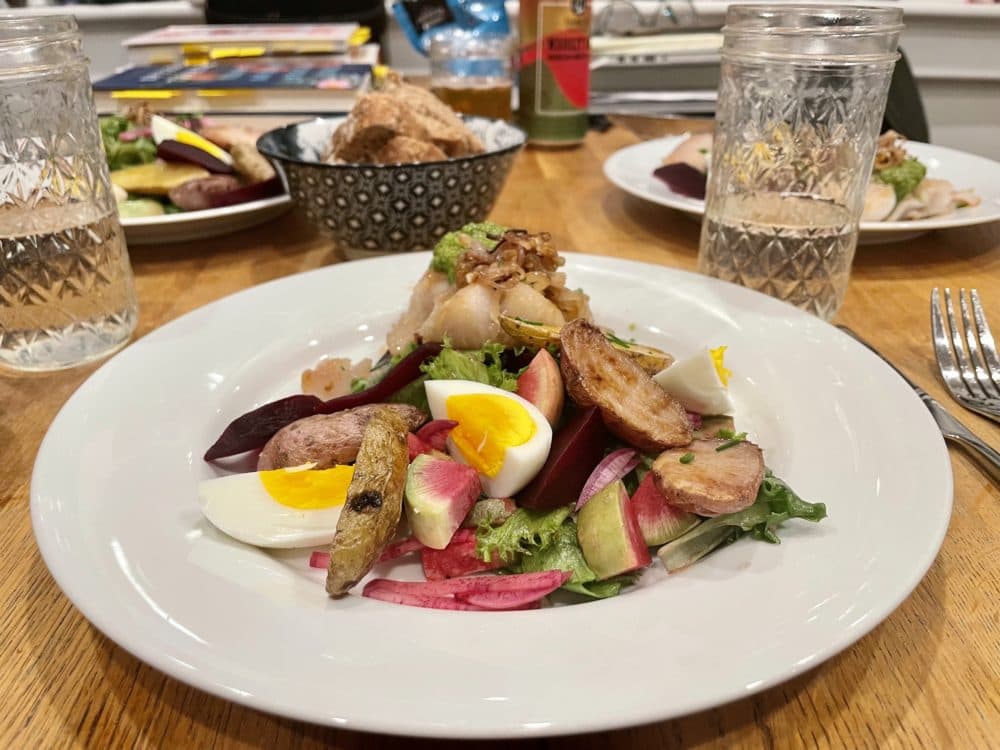 Andrea's 100% local meal with Susy Jones of hake, potatoes, rainbow radish, purple daikon, shallots, egg and ramp dressing. (Andrea Shea/WBUR)