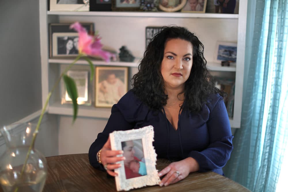 Michelle Pavlov holds a photo of her now 7-year-old son, Declan. Pavlov says she was fired from her job in 2015, because she was pregnant. (John Tlumacki/The Boston Globe)