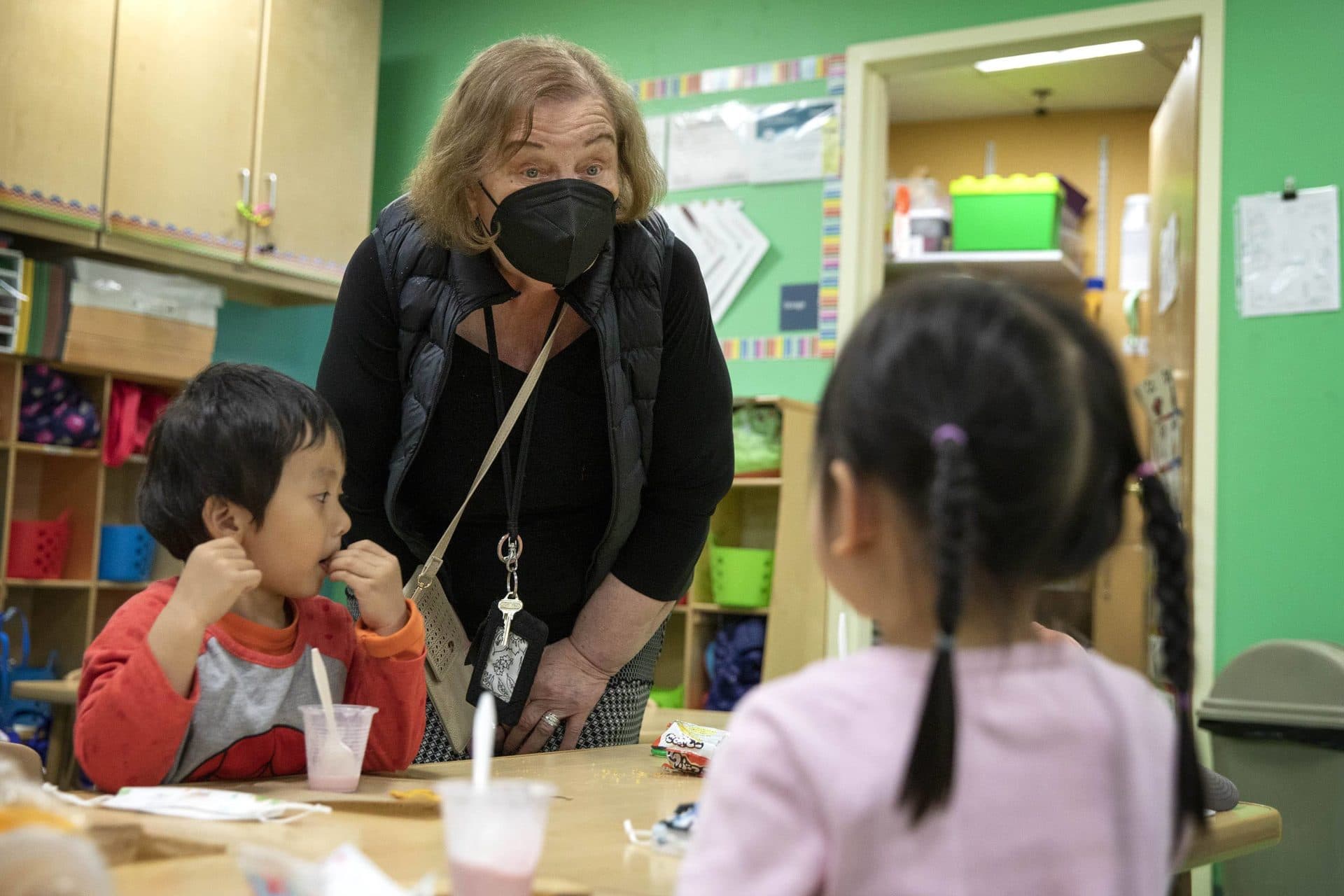 Bernadette Davidson, director of child care at the Boston Chinatown Neighborhood Center, talks with some of the kids at the center. (Robin Lubbock/WBUR)