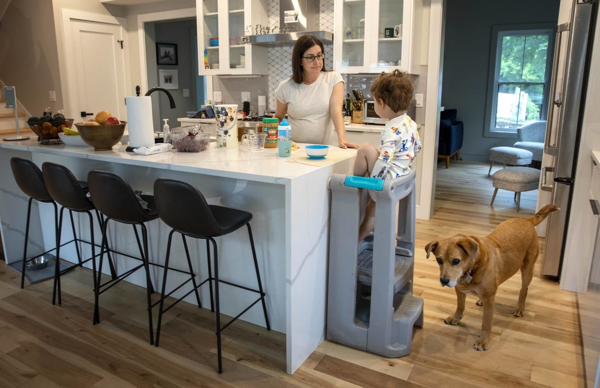 Foster, the dog, joins Sarah Berkley and Cole as they have breakfast. (Robin Lubbock/WBUR)
