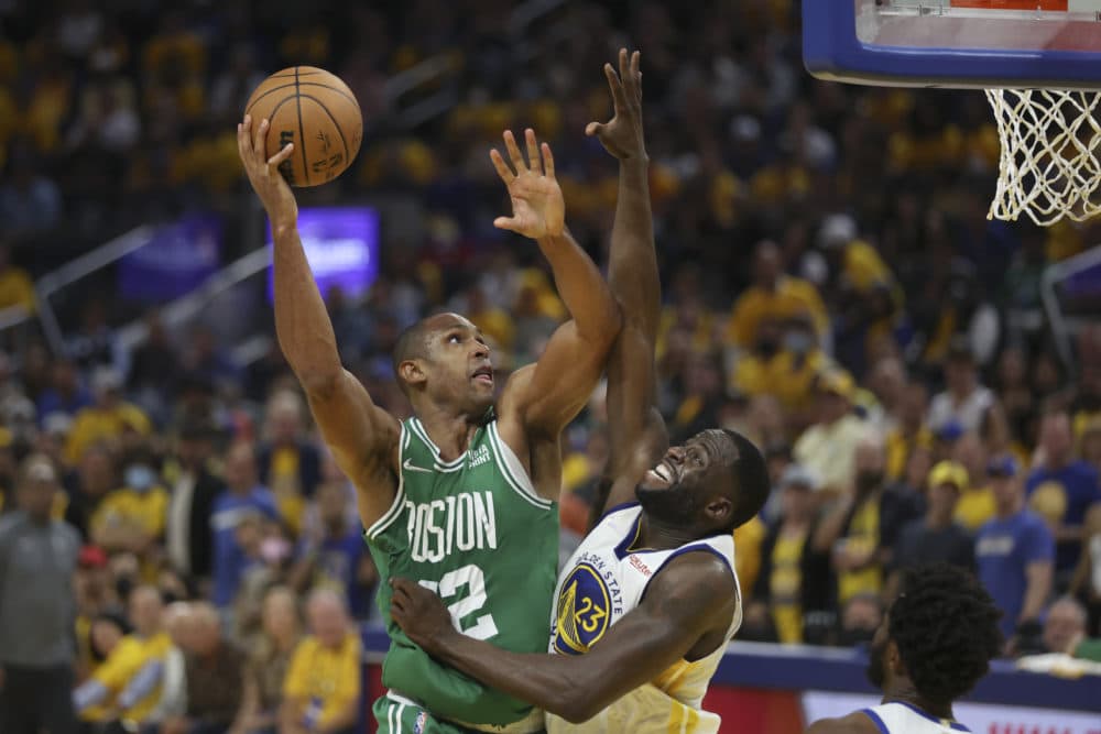 Boston Celtics center Al Horford, left, shoots against Golden State Warriors forward Draymond Green during the second half of Game 1 of basketball's NBA Finals in San Francisco on Sunday. (Jed Jacobsohn/AP)