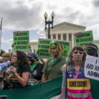 Abortion-rights protesters following Supreme Court's decision to overturn Roe v. Wade, federally protected right to abortion, in Washington, Friday, June 24. (Gemunu Amarasinghe/AP)