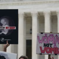 Pro-choice and pro-life signs are seen outside the US Supreme Court in Washington, DC, on June 24, 2022. - The US Supreme Court on Friday ended the right to abortion in a seismic ruling that shreds half a century of constitutional protections on one of the most divisive and bitterly fought issues in American political life. The conservative-dominated court overturned the landmark 1973 "Roe v Wade" decision that enshrined a woman's right to an abortion and said individual states can permit or restrict the procedure themselves. (Photo by Olivier DOULIERY / AFP) (Photo by OLIVIER DOULIERY/AFP via Getty Images)