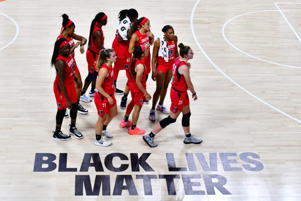 The Atlanta Dream walk by the Black Lives Matter graphic on the court following a 100-70 loss to the Las Vegas Aces at Feld Entertainment Center on July 29, 2020 in Palmetto, Florida. (Julio Aguilar/Getty Images)