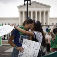 Abortion rights activists Carrie McDonald (L) and Soraya Bata react to the Dobbs v Jackson Women’s Health Organization ruling which overturns the landmark abortion Roe v. Wade case in front of the U.S. Supreme Court on June 24, 2022 in Washington, DC. (Anna Moneymaker/Getty Images)