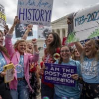 Anti-abortion protesters celebrate following Supreme Court's decision to overturn Roe v. Wade on June 24. (Gemunu Amarasinghe/AP)