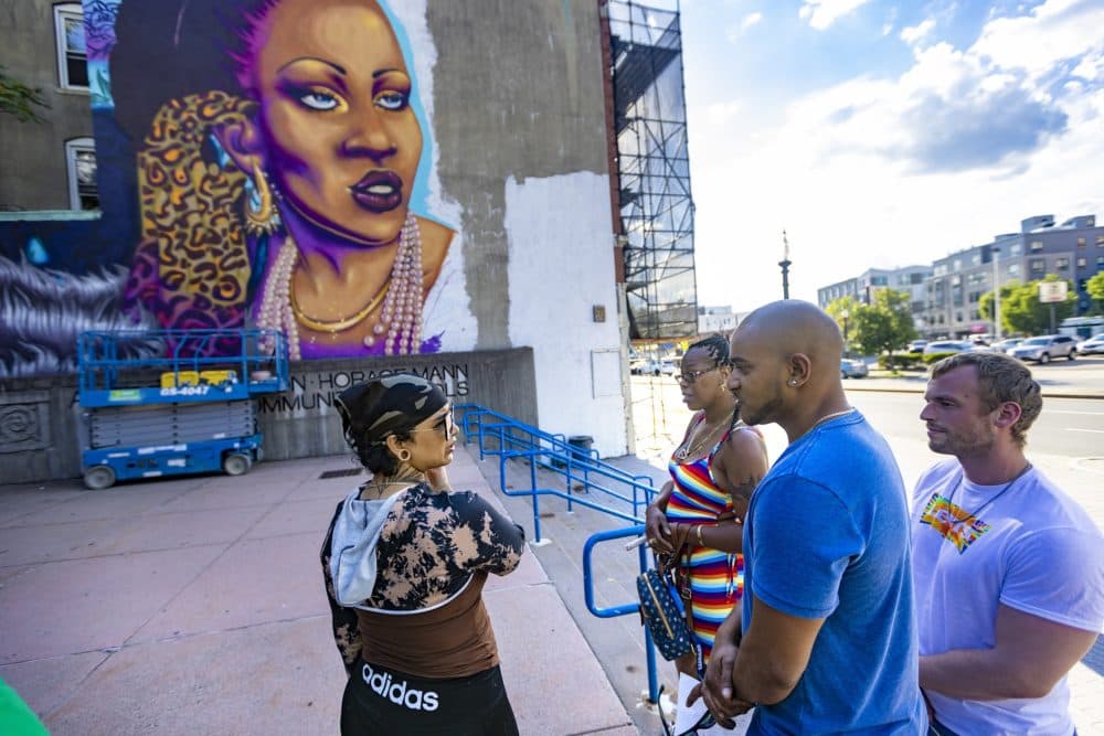 Le neveu Taufiq Chowdhury et sa soeur Kim Hester parlent avec l'artiste Rixy lorsqu'ils arrivent sur le site où "Rita's Spotlight" est en cours d'installation à Allston. (Jesse Costa/WBUR)